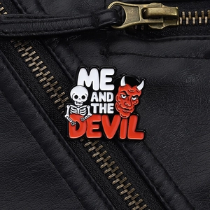 Detail of Me and the Devil skull enamel pin badge on a black leather jacket