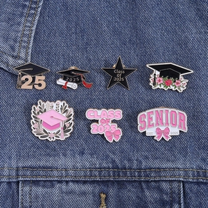 Detailed set of seven 2025 graduation enamel pins on denim with cute floral and cap designs