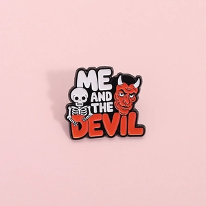 Cute enamel skull and red devil pin badge featuring Me and the Devil artistic text