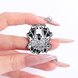 Detail of Cats World Domination enamel pin with black cats and ghosts on books