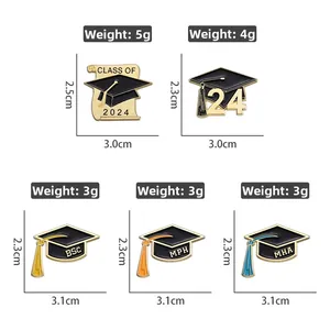 Detail view of 2025 graduation enamel pins with mortarboard and academic degree acronyms