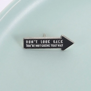 Minimalist black arrow enamel pin with silver inspirational Don't Look Back quote
