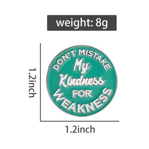 Detailed view of green round enamel pin with quote measuring 1.2 inches by 1.2 inches