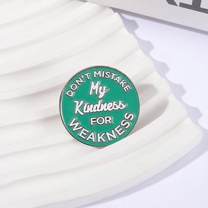 Minimalist round enamel brooch with kindness quote in teal green and silver finish