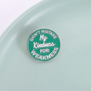 Minimalist round mint green enamel brooch with Don't Mistake My Kindness quote