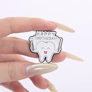 Close-up of a happy tooth enamel pin with toothbrush, mirror and funny slogan
