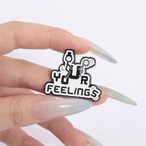 Detail of stick figure enamel pin with Your Feelings text held by long glitter nails