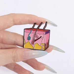 Detailed enamel pin showing human skin anatomy layers including hair follicle and dermis