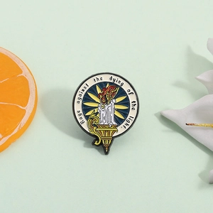Enamel brooch with burning candle and Rage against the dying of the light quote