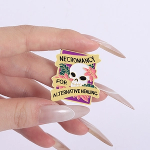 Detailed close-up of a colorful enamel skull brooch featuring floral necromancy design