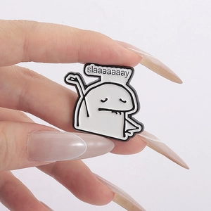 Detail of Flork meme enamel pin badge with 'slaaaaaaay' text held by manicured fingers