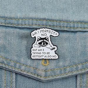 Cute raccoon enamel pin with humor quote on blue denim jacket pocket accessory