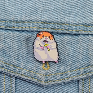 Cute enamel hamster pin with yellow cross on denim jacket, creative cartoon animal brooch