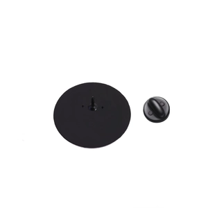 Detail of round brooch back with black metal base and rubber butterfly clutch pin