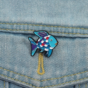 Creative tropical fish enamel brooch on denim jacket with colorful ocean life design