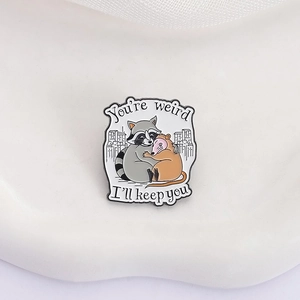 Cute raccoon and opossum enamel brooch with You're weird and I'll keep you text