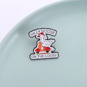 Funny white goose riding a red scooter enamel pin with Silly Goose On The Loose text
