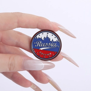 Close-up of circular Russian enamel pin with St. Basil's Cathedral and flag colors