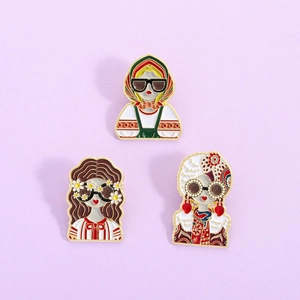 Three enamel pins featuring modern cartoon figures in traditional Russian folk costumes