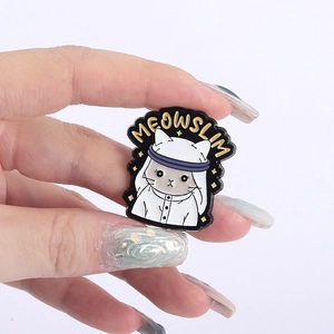 Detailed view of Meowslim cat enamel pin with white Keffiyeh and gold stars
