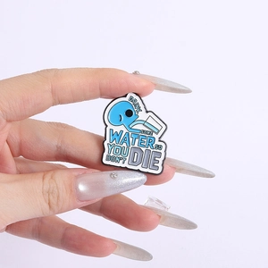 Detail of blue water drop enamel pin with text Drink Some Water So You Don't Die