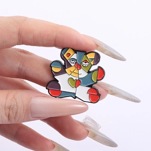 Close-up of geometric colorful enamel bear brooch with artistic oil painting style