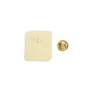 Detail view of the gold-plated metal brooch back with sandblasted texture and butterfly clutch