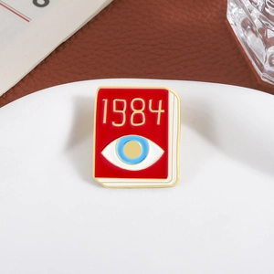 Creative red book enamel brooch featuring 1984 theme and blue eye motif on metal base