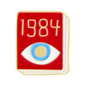 Red enamel book brooch featuring 1984 gold text and blue eye on white background