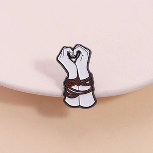 Creative enamel brooch featuring bound hands forming a heart shape with red rope detail