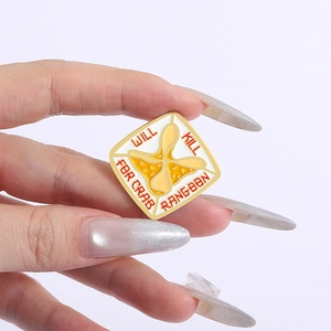 Macro detail of enamel crab rangoon badge with Will Kill For Crab Rangoon text slogan