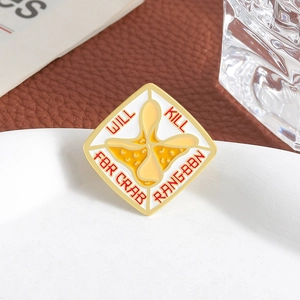 Funny Crab Rangoon enamel brooch pin with Will Kill for Crab Rangoon text on a table