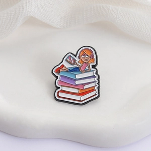Cartoon girl with pink headphones lying on colorful books enamel lapel pin badge