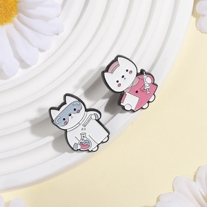 Close-up of cute cartoon scientist and nurse cat enamel pins on a white display stand