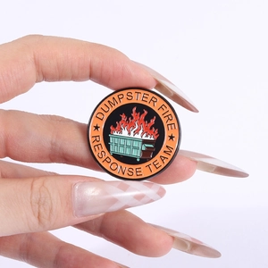 Macro view of Dumpster Fire Response Team enamel pin with vibrant green trash can design
