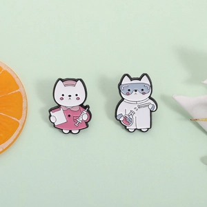 Detail shot of cute enamel pins showing a nurse cat and a scientist cat with lab gear