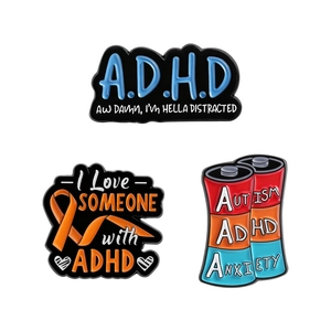 Three-piece ADHD awareness enamel pin set featuring mental health slogans and battery design