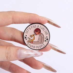 Detail of pink enamel brooch showing a scientist and microscope with slogan text