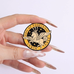 Close-up of Son of Poseidon enamel pin with Pegasus and trident in hand view
