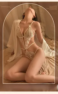 Detailed view of white lace bodysuit with bow detail and silk robe on a model