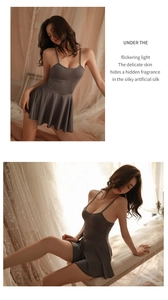 Close-up of silky deep grey lingerie dress with delicate straps and pleated hem