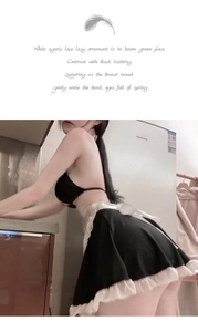 Detail of maid costume featuring black lace bodice and white satin bow in home kitchen