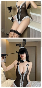 Close-up of black mesh bunny girl lingerie with white lace trim and bow accessories