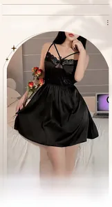 Detail of black silk nightgown featuring delicate lace trim and ribbon bow decoration