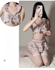 Detail of schoolgirl lingerie set with white halter top and pink plaid pleated skirt