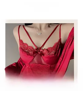 Detail shot of red silk and lace nightgown featuring a bow and sheer mesh stitching