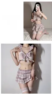 Detail of sexy plaid schoolgirl uniform with bow-knot top, pleated skirt and lace stockings