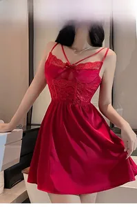 Detailed view of red silk satin nightgown featuring intricate lace patchwork and slim straps