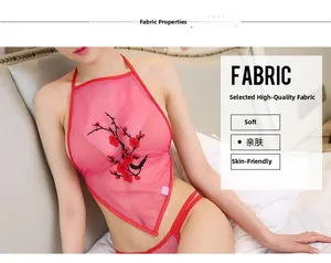 Detailed view of pink sheer mesh lingerie featuring plum blossom embroidery on a babydoll