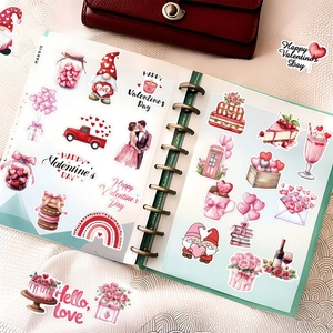 Detailed view of Valentine stickers with hearts and flowers in a planner book